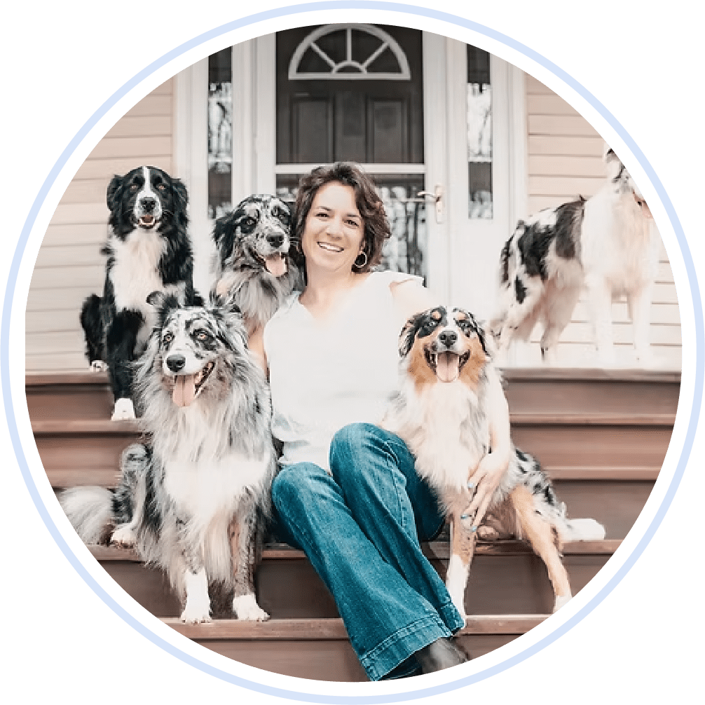 Dr. Vanessa Ferraz Sitting On Porch With Group Of Dogs