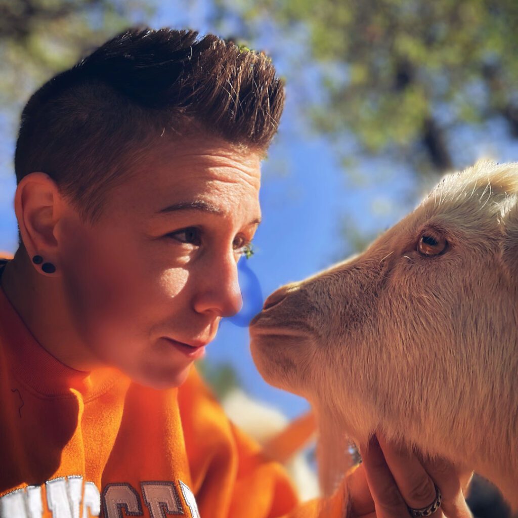 Kellie Dawald petting a goat